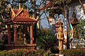 Vientiane, Laos - Pha That Luang, Other structures on the ground include a bell tower, several stupas, a number of pavilions sheltering images of the Buddha. 